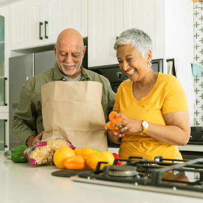 man and woman emptying grocery bag